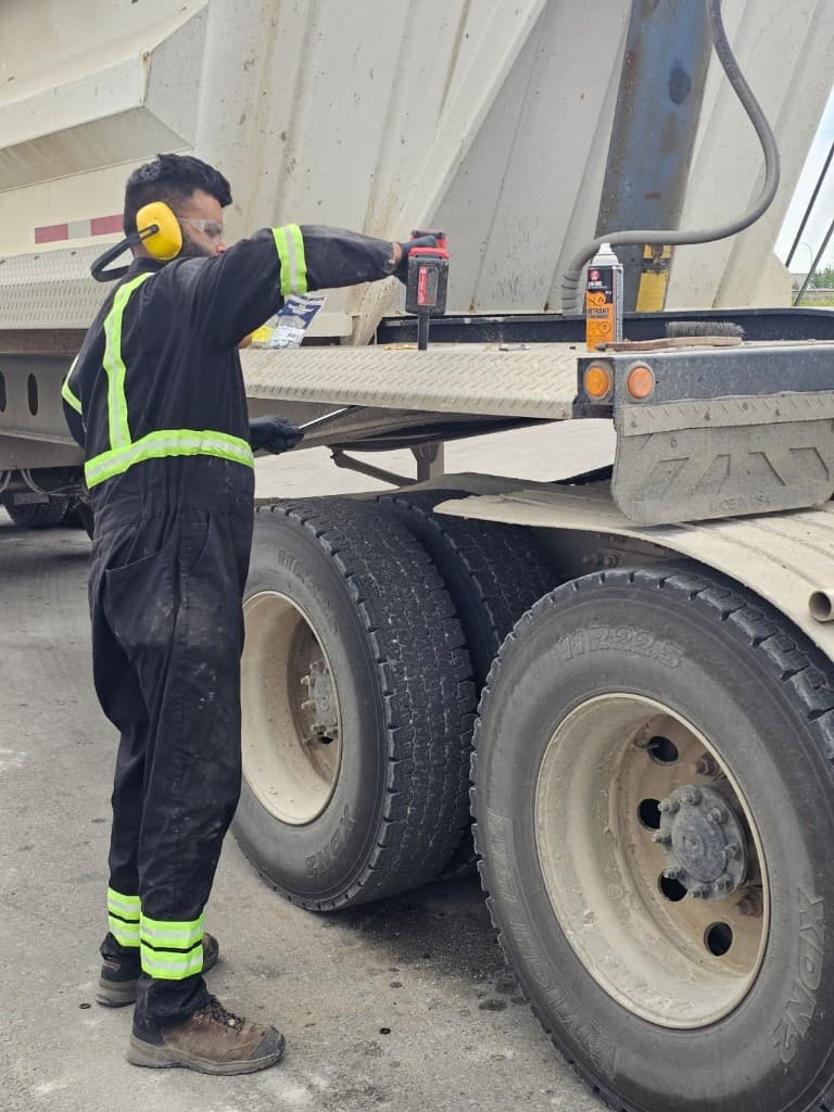 Hub Transport technician performing on-site fleet service on a commercial trailer